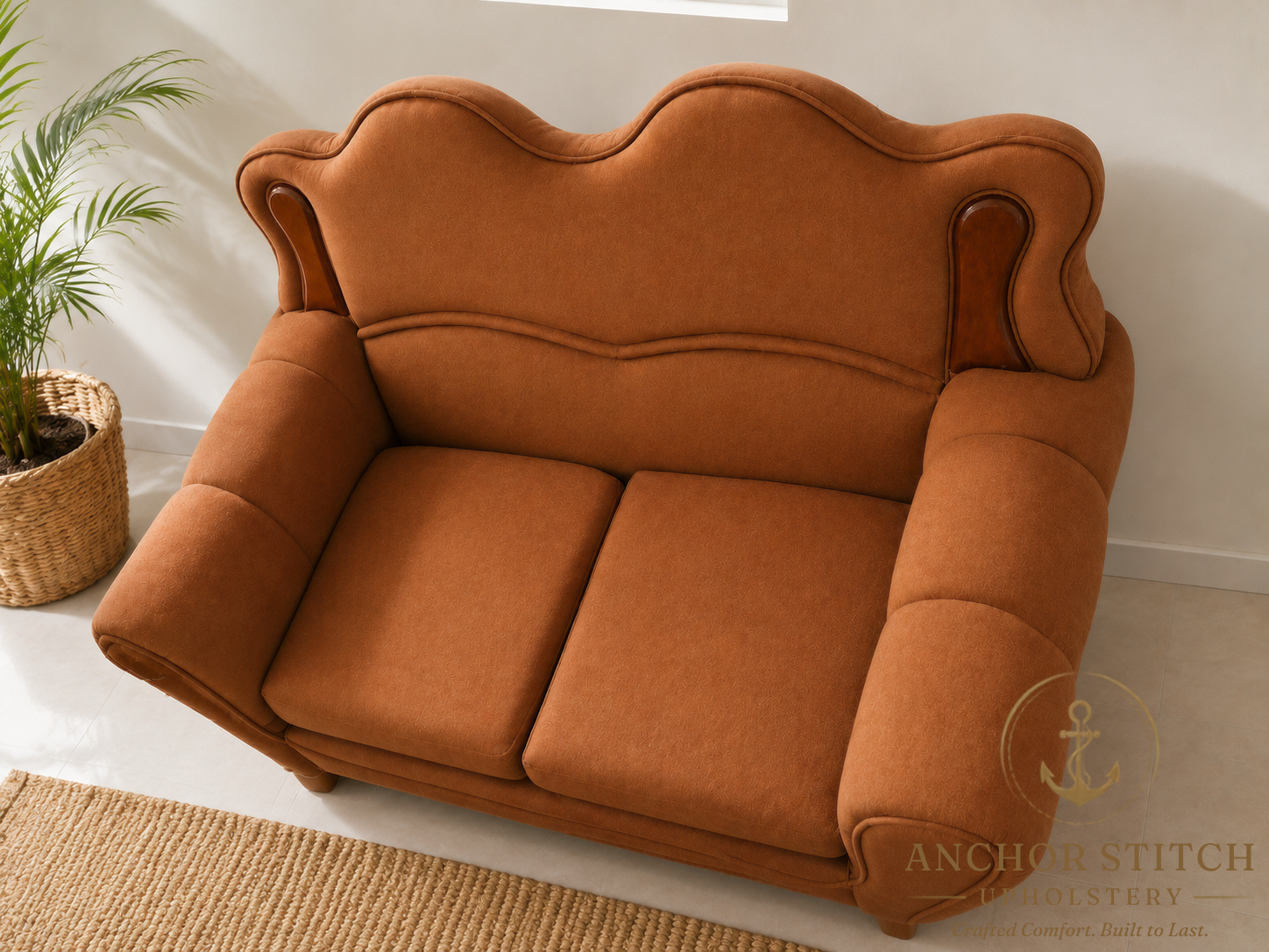 A scalloped-back loveseat brought back to life in warm terracotta upholstery